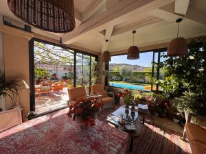a living room with a view of a pool at La Bastide des Romarins in Plan-dʼOrgon