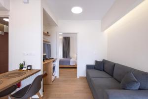 a living room with a couch and a table at Enalis Studios & Apartments in Karfas