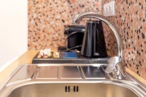 a kitchen sink with a faucet on a counter at Enalis Studios & Apartments in Karfas