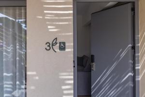 a door to a house with a sign on it at Enalis Studios & Apartments in Karfas +55 photos