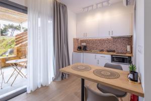 a kitchen with a table and a counter top at Enalis Studios & Apartments in Karfas