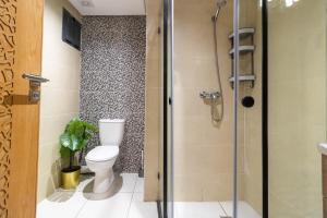 a bathroom with a toilet and a shower at Blue Waves 2 Bedrooms with Pool in Bouznika