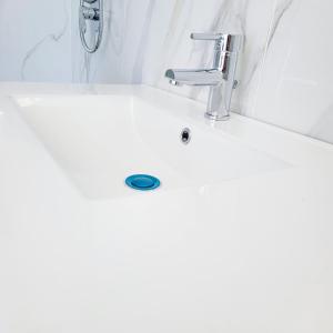 a white bathroom sink with a faucet at Suite Ekaterina Sunsets 2 minuti dal mare in Brolo +22 photos