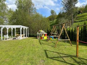 a park with a swing set and a playground at Gasthaus Radków in Radków
