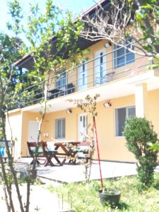 a building with a picnic table in front of it at Sonja Sea View House in Zagrađe