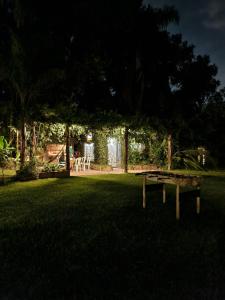 a park with a bench in the grass at Cabaña La Mechita con jacuzzi privado in Estación Delta