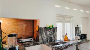 a kitchen with a sink and a counter top at Samson & Ruby Villa in Weligama