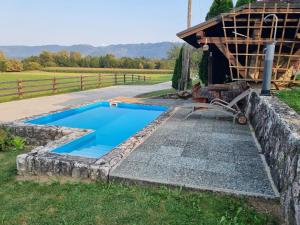 a swimming pool in a yard next to a house at western cottage in Rečica ob Savinji