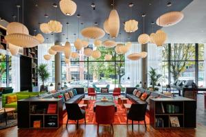 a lobby with couches and tables and lamps at citizenM Seattle South Lake in Seattle