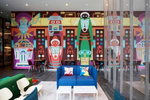 a room with a colorful mural on the wall at citizenM Seattle South Lake in Seattle +29 photos