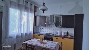a kitchen with a table with a table cloth on it at Casa Kendra in Montegrotto Terme