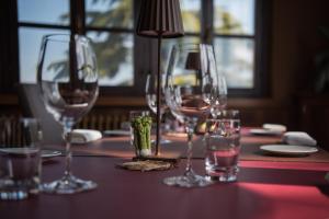 a table with four wine glasses on a table at Locanda Orticello in Monferrato in Cremolino