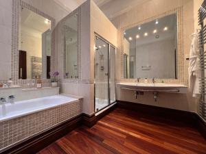 a large bathroom with a tub and a sink at Morgans Hotel in Swansea +45 photos