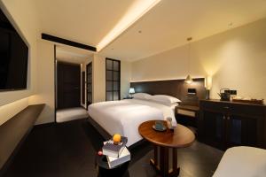 a hotel room with a bed and a table at Chengdu Yunduo 云朵Hotel in Chengdu
