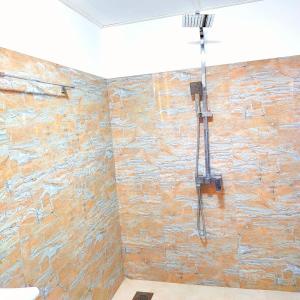 a bathroom with a stone wall with a shower at Samson & Ruby Villa in Weligama +57 photos