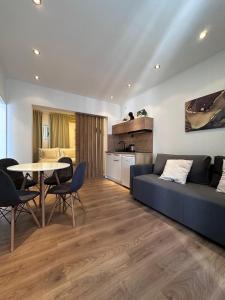 a living room with a blue couch and a table at Apartments Vukovic in Selce