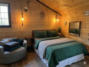 a bedroom with a bed and a chair at Charming "Melrose Place" w Year-Round Heated Pool, Deck & Grill in Victoria