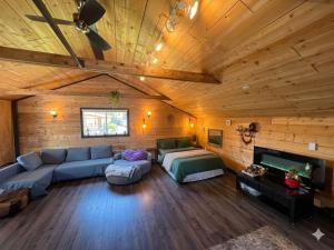 a large living room with a couch and a tv at Charming "Melrose Place" w Year-Round Heated Pool, Deck & Grill in Victoria