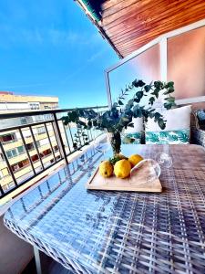 a table with fruit on it on a balcony at Sueña Mar Luxury Suites in Torrevieja
