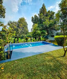 a swimming pool in the yard of a house at solomons ark luxury pool villa in Cochin