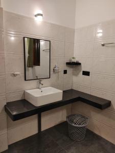 a bathroom with a sink and a mirror at Nature Velora Villa in Tangalle +25 photos