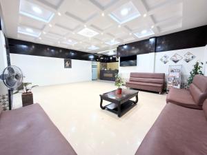 a waiting room with couches and a coffee table at Malaysia inn in Chennai