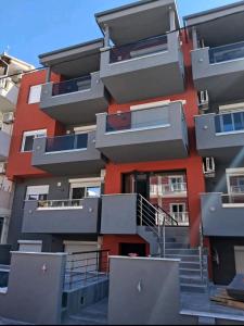 a tall building with stairs in front of it at Blue Wave in Paralia Katerinis
