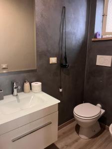 a bathroom with a white sink and a toilet at Martina Fillungo Loft in Lucca