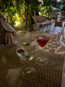 two glasses of wine sitting on a table at cali stays in Chapora