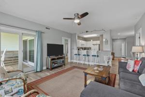 a living room with a couch and a table at Wicked Fun at Windswept Ridge in Corolla