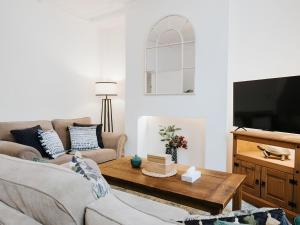 a living room with a couch and a coffee table at St Helens 3BR Home with Garden, Fast WiFi, Smart TV, Sleeps 6, Contractors & Long Stay Accommodation in Saint Helens +23 photos
