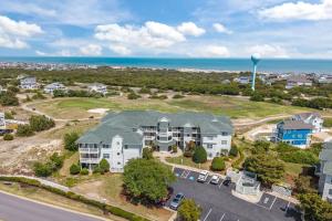 an aerial view of a house with the ocean in the background at Wicked Fun at Windswept Ridge in Corolla
