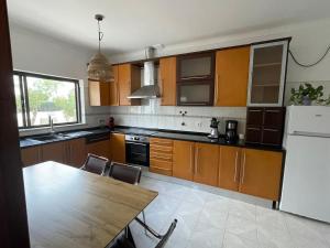 a kitchen with a table and a white refrigerator at Large 2 bedroom Lagos apartment in Lagos