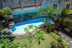 a painting of a pool in a yard with plants at Nusa Dua Moon Hotel in Nusa Dua