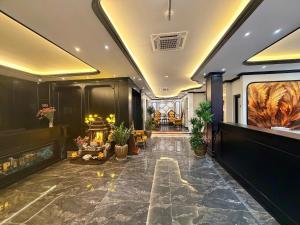 a lobby of a building with plants in it at Green Luxury Hotel in Hà Ðông