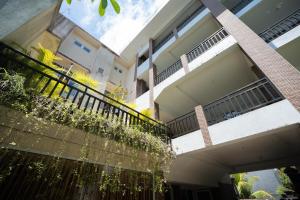 a building with a balcony with plants on it at Nusa Dua Moon Hotel in Nusa Dua