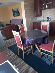 a table and chairs in a kitchen with a table and a sink at Sonja Sea View House in Zagrađe +13 photos