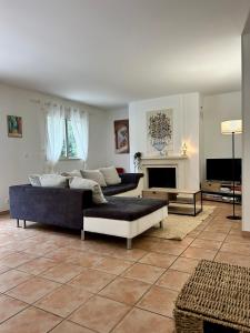a living room with a couch and a fireplace at La Maison du Square in La Teste-de-Buch