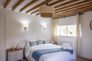 a bedroom with a bed and a large window at The Ash Tree in Ashendon
