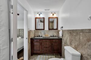 a bathroom with a sink and a toilet and mirrors at Coffee | Streaming TV | Fast WIFI | Pet Friendly in Seaside Heights +17 photos