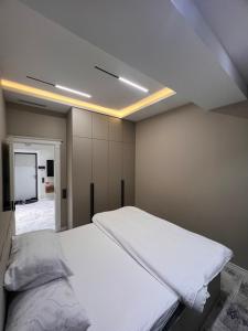 a bedroom with a white bed in a room at Rakhim bobo 2 in Bukhara