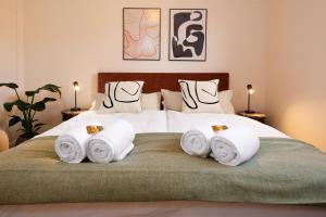 a bedroom with a bed with towels on it at PLEIB COLOGNE - Premium Suites in Cologne