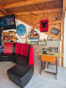 a room with a desk and a chair and a table at Rooms and Apartments Analipsi in Shëngjin