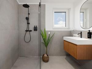 a bathroom with a shower and a sink and a shower at PLEIB COLOGNE - Premium Suites in Cologne +79 photos