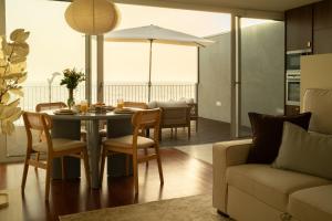 a dining room with a table and chairs and a couch at Casanova Seaside in Porto