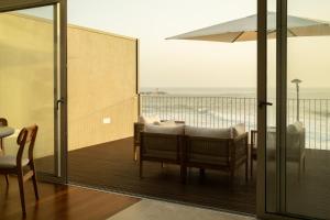 a room with a balcony with a view of the ocean at Casanova Seaside in Porto