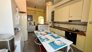 a kitchen with a table with dishes on it at WELCOME - Scilla Casa Vacanze in Scilla +8 photos