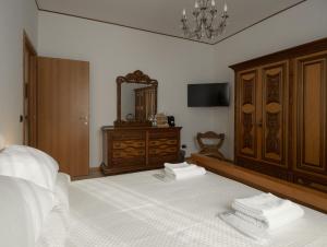 a bedroom with a bed with a dresser and a mirror at Antonio Rooms 2 in Parma