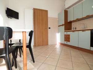 a kitchen with a table and chairs in a room at Antonio Rooms 2 in Parma +14 photos