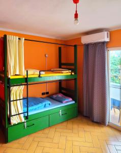 two bunk beds in a room with an orange wall at Villa Villekulla in Tirana